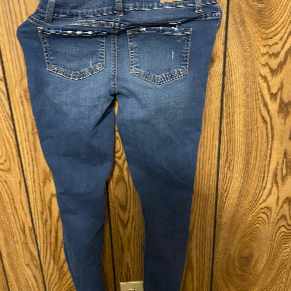 Blue justice jeans, has rips on the knees,